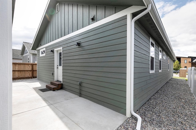 5576 Cattle Dr, Missoula, MT 59808 - view of home's exterior with entry steps, board and batten siding, and a patio area