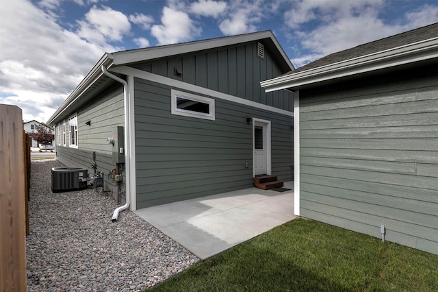 5576 Cattle Dr, Missoula, MT 59808 - rear view of property featuring board and batten siding, entry steps, a patio area, and cooling unit