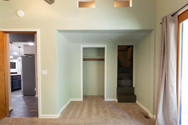 6400 Boondock Ln, Clinton, MT 59825 - unfurnished bedroom with carpet floors, freestanding refrigerator, and a closet