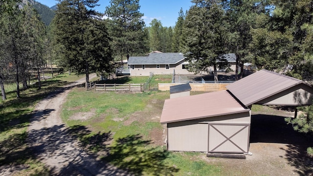 view of subject property with a forest