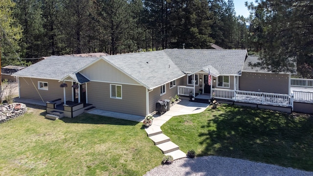 6400 Boondock Ln, Clinton, MT 59825 - ranch-style house with roof with shingles, a front lawn, and a wooden deck