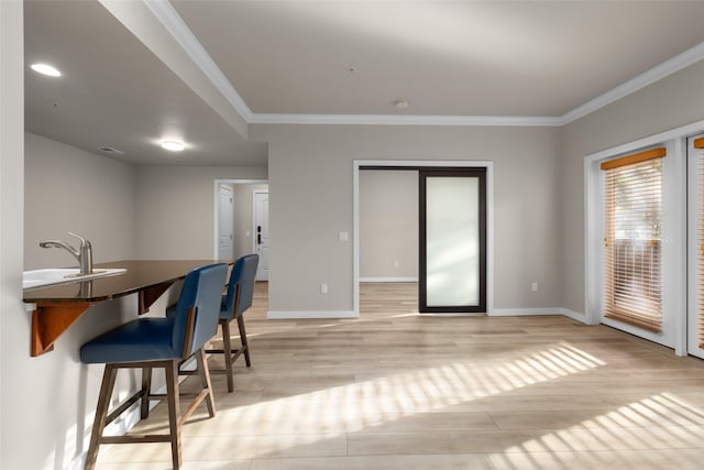 6002 St Moritz Dr Unit A, Whitefish, MT 59937 - dining space featuring crown molding, light wood-style flooring, and baseboards