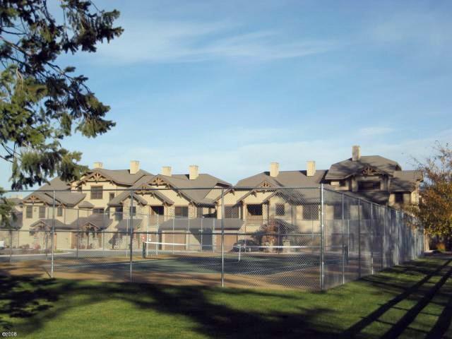 6002 St Moritz Dr Unit A, Whitefish, MT 59937 - view of tennis court with fence and a residential view