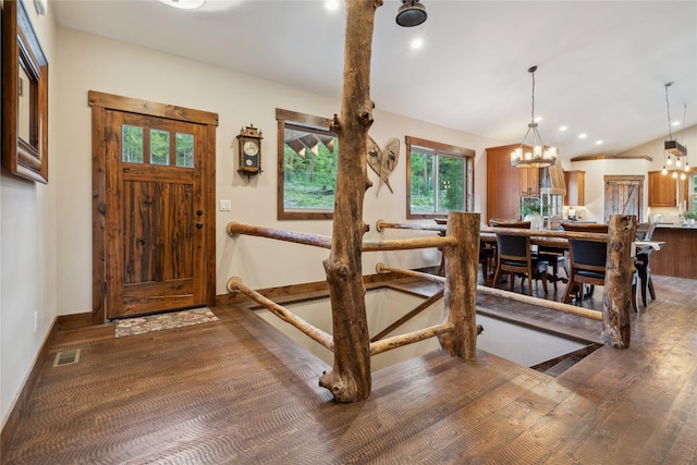 200 Lakeview Ter, Marion, MT 59925 - foyer entrance featuring a chandelier, vaulted ceiling, baseboards, and wood finished floors