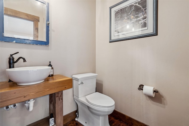 200 Lakeview Ter, Marion, MT 59925 - bathroom with a sink, toilet, wood finished floors, and baseboards