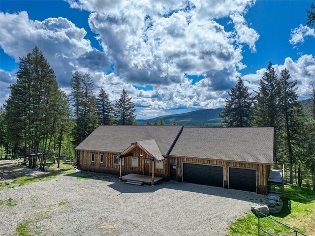200 Lakeview Ter, Marion, MT 59925 - view of front of house featuring gravel driveway, a garage, and board and batten siding
