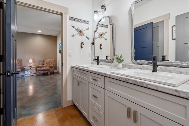 200 Lakeview Ter, Marion, MT 59925 - bathroom featuring finished concrete floors, baseboards, double vanity, and recessed lighting