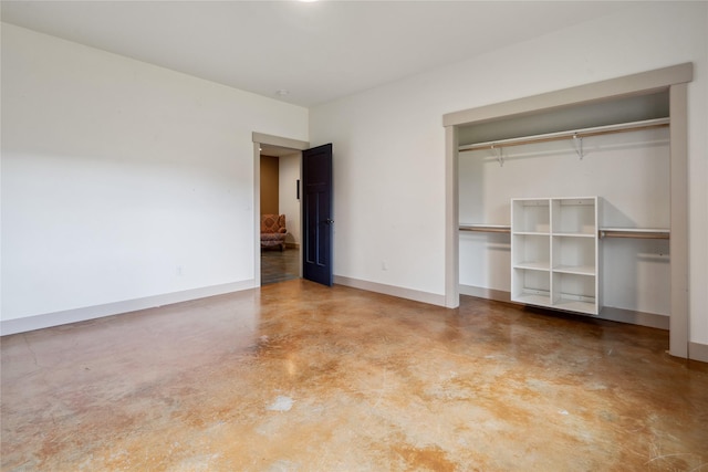 200 Lakeview Ter, Marion, MT 59925 - unfurnished bedroom with finished concrete flooring, a closet, and baseboards