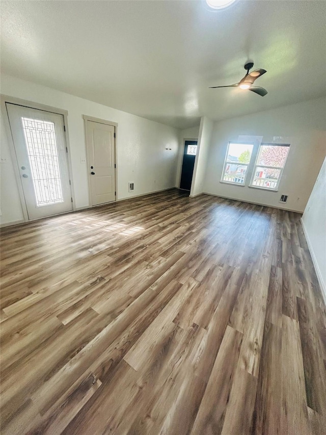 4 Weber Ave, Polson, MT 59860 - unfurnished living room with wood finished floors, ceiling fan, and baseboards