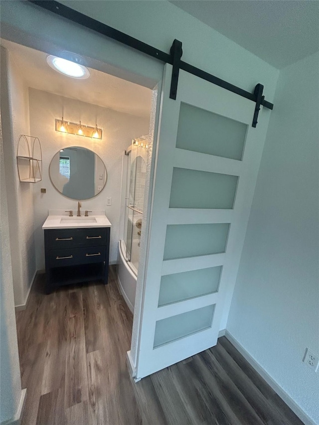 4 Weber Ave, Polson, MT 59860 - full bath featuring built in features, wood finished floors, vanity, baseboards, and shower / bath combination with glass door