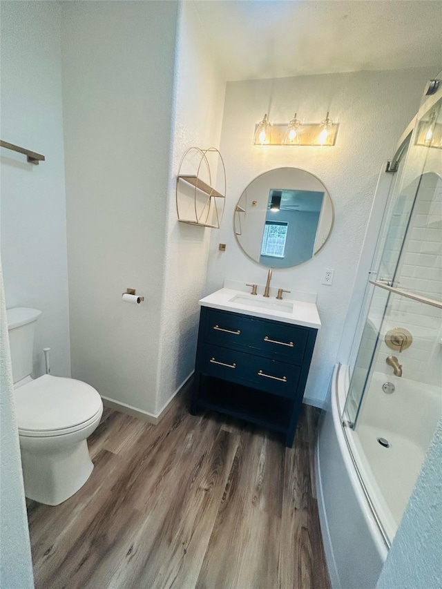 4 Weber Ave, Polson, MT 59860 - bathroom with wood finished floors, toilet, vanity, combined bath / shower with glass door, and baseboards