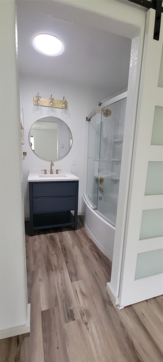 4 Weber Ave, Polson, MT 59860 - full bathroom with vanity, wood finished floors, bath / shower combo with glass door, and built in features