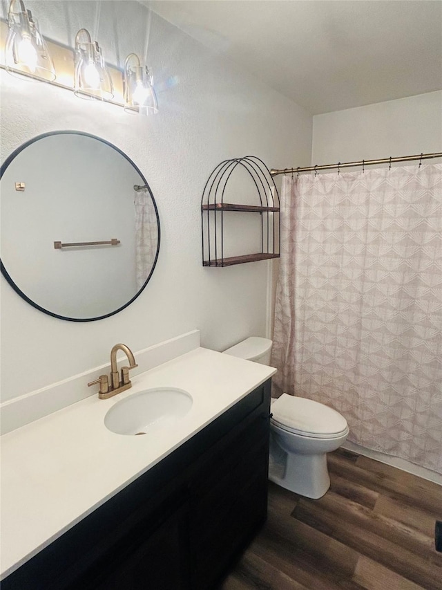 4 Weber Ave, Polson, MT 59860 - full bathroom with wood finished floors, vanity, toilet, and a shower with shower curtain