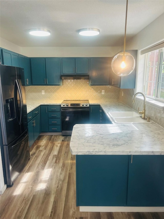 4 Weber Ave, Polson, MT 59860 - kitchen featuring black refrigerator with ice dispenser, stainless steel electric range oven, a sink, blue cabinets, and a peninsula