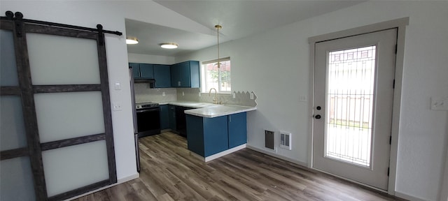 4 Weber Ave, Polson, MT 59860 - kitchen with blue cabinets, range with electric stovetop, a sink, wood finished floors, and lofted ceiling