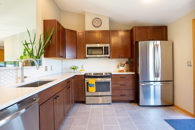 2504 Blackthorn Dr, Missoula, MT 59803 - kitchen with stainless steel appliances, a sink, tasteful backsplash, light countertops, and light tile patterned floors