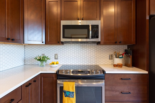 2504 Blackthorn Dr, Missoula, MT 59803 - kitchen with stainless steel appliances, light countertops, and backsplash