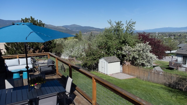2504 Blackthorn Dr, Missoula, MT 59803 - wooden deck featuring an outdoor hangout area, a mountain view, a shed, and an outbuilding