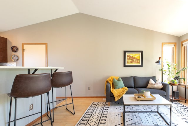2504 Blackthorn Dr, Missoula, MT 59803 - living room featuring vaulted ceiling, light wood-type flooring, and baseboards