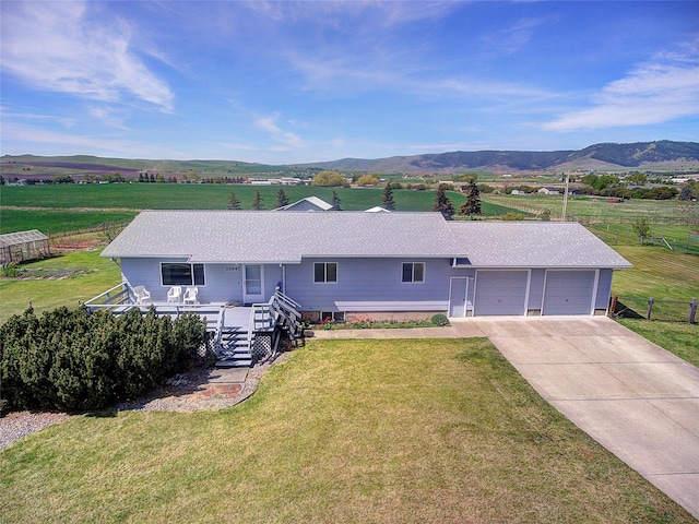 single story home featuring a garage, a mountain view, a porch, driveway, and stairway