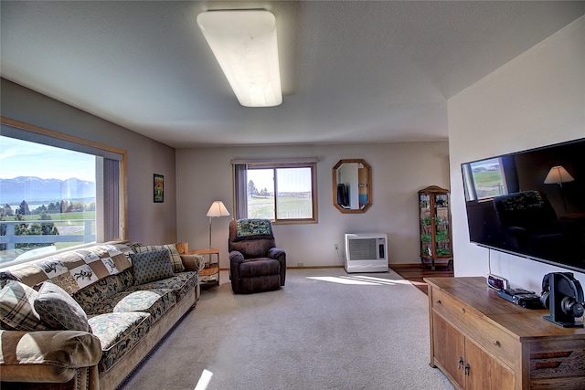living area with carpet flooring, baseboards, and a mountain view