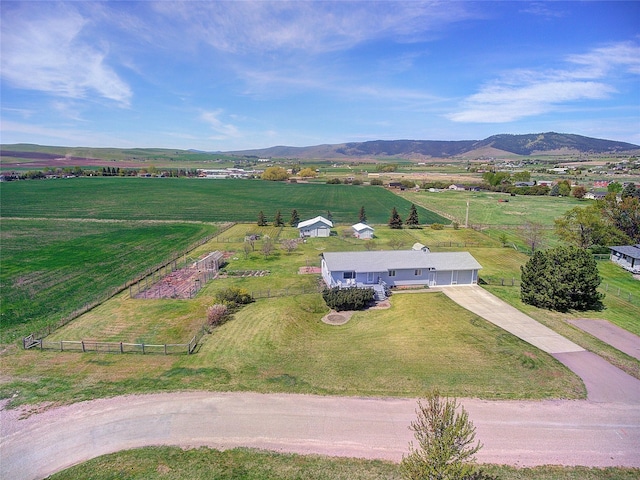 view of rural area featuring a mountain backdrop and a pastoral area