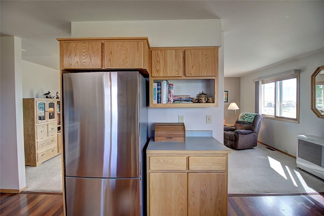 kitchen with freestanding refrigerator, dark wood-style flooring, light brown cabinetry, and dark carpet