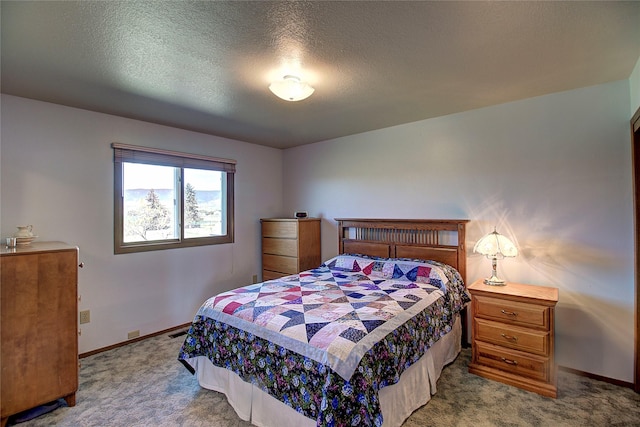 bedroom featuring carpet floors, baseboards, and a textured ceiling