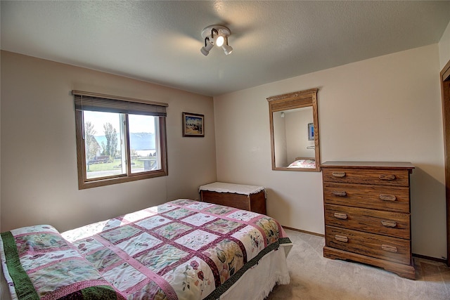bedroom with light carpet and baseboards