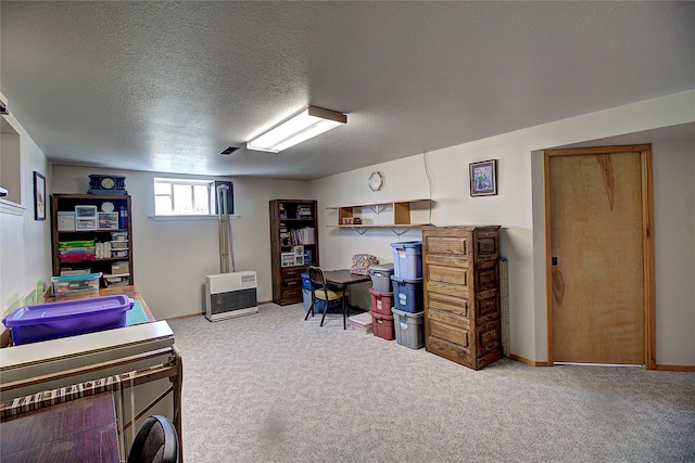 bedroom featuring carpet floors, heating unit, a textured ceiling, and baseboards