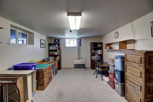 home office featuring a textured ceiling and carpet