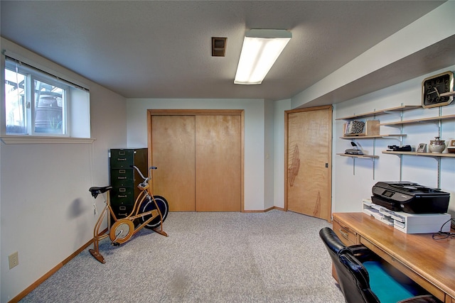 carpeted home office with baseboards