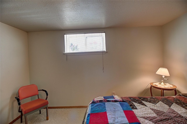 bedroom with carpet flooring, a textured ceiling, and baseboards