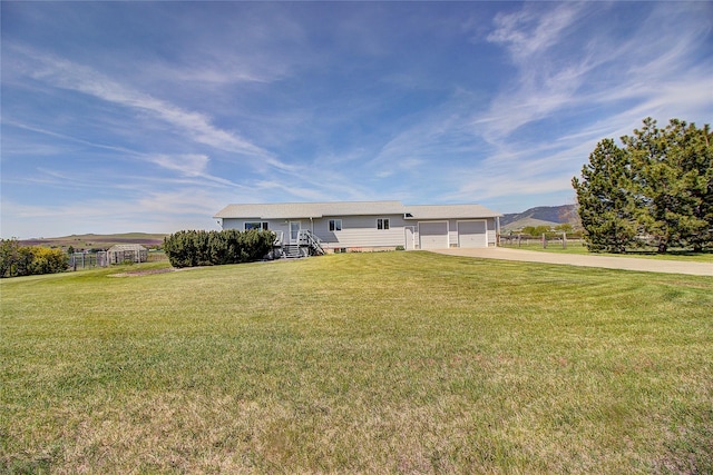 view of front of house featuring concrete driveway, a mountain view, and a garage