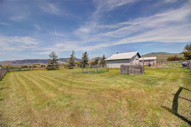 view of yard with a mountain view and a view of rural / pastoral area