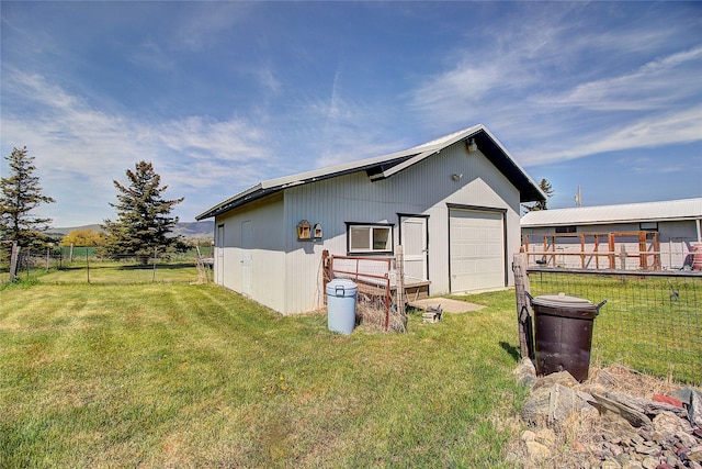 rear view of property with an outdoor structure and a pole building