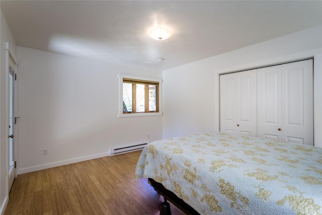 2406 Raymond Ave, Missoula, MT 59802 - bedroom featuring baseboard heating, wood finished floors, baseboards, and a closet