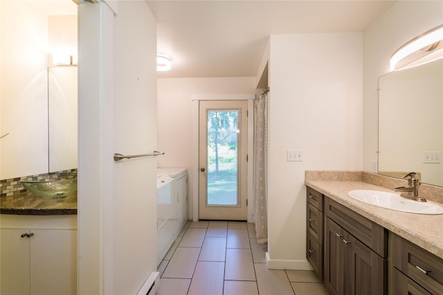 2406 Raymond Ave, Missoula, MT 59802 - full bath with washer and clothes dryer, tile patterned flooring, two vanities, and baseboards