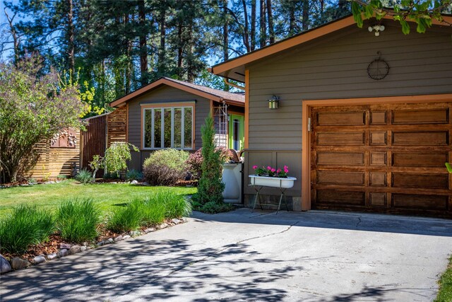 2406 Raymond Ave, Missoula, MT 59802 - view of front of house featuring asphalt driveway, an attached garage, and a front lawn