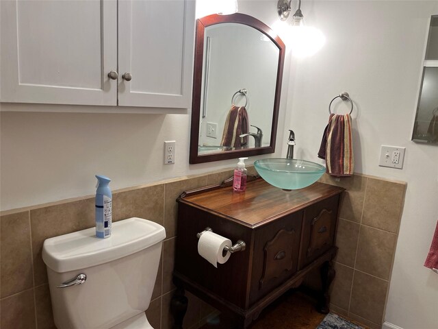 403 S Cherry St, Townsend, MT 59644 - bathroom with tile walls, wainscoting, vanity, and toilet