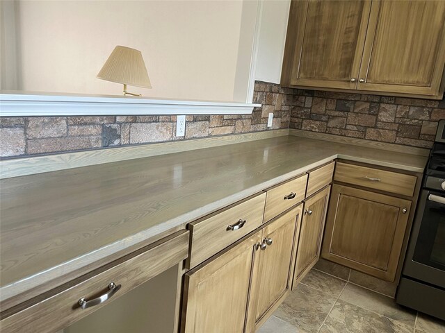403 S Cherry St, Townsend, MT 59644 - kitchen featuring backsplash, light stone finish floors, and light countertops