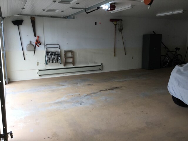 403 S Cherry St, Townsend, MT 59644 - garage featuring a baseboard heating unit and a garage door opener