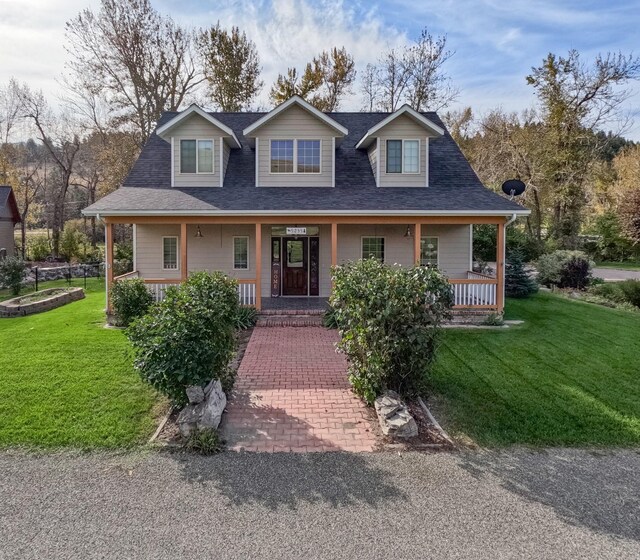 5235 Creekside Ln, Helena, MT 59601 - view of front of house with covered porch, a front lawn, and a shingled roof