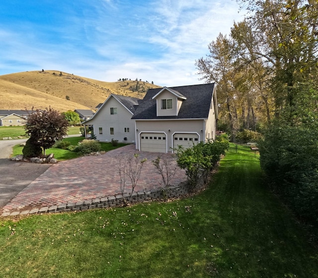 5235 Creekside Ln, Helena, MT 59601 - view of side of home with driveway, a yard, and a mountain view