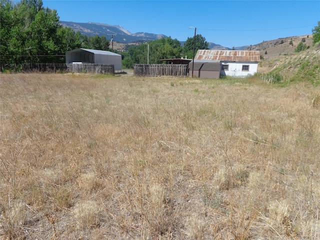 314 Washoe Park Rd, Anaconda, MT 59711 - view of yard with a detached carport, a mountain view, and fence
