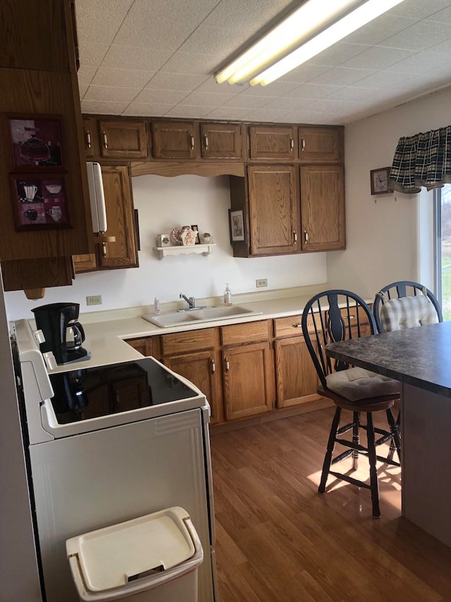 470 Duck Lake Rd, Browning, MT 59417 - kitchen with a sink, range with electric cooktop, dark wood-style floors, open shelves, and brown cabinets