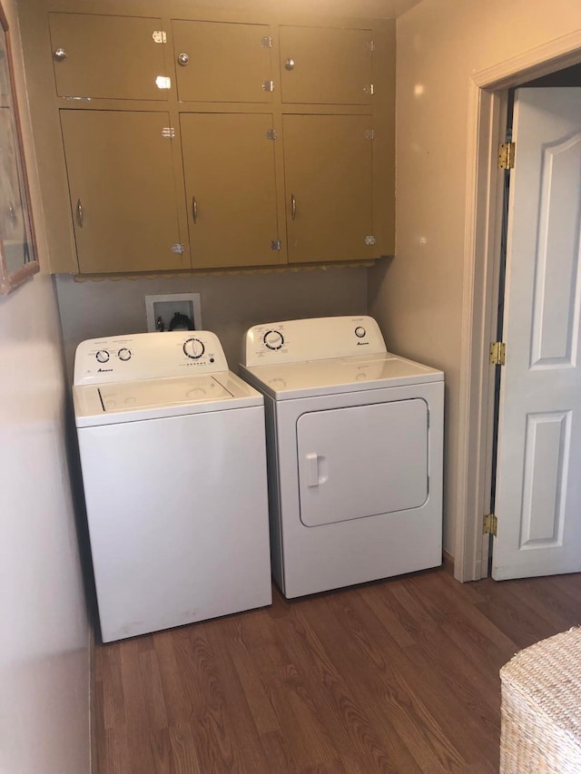 470 Duck Lake Rd, Browning, MT 59417 - washroom with cabinet space, dark wood-style floors, and separate washer and dryer