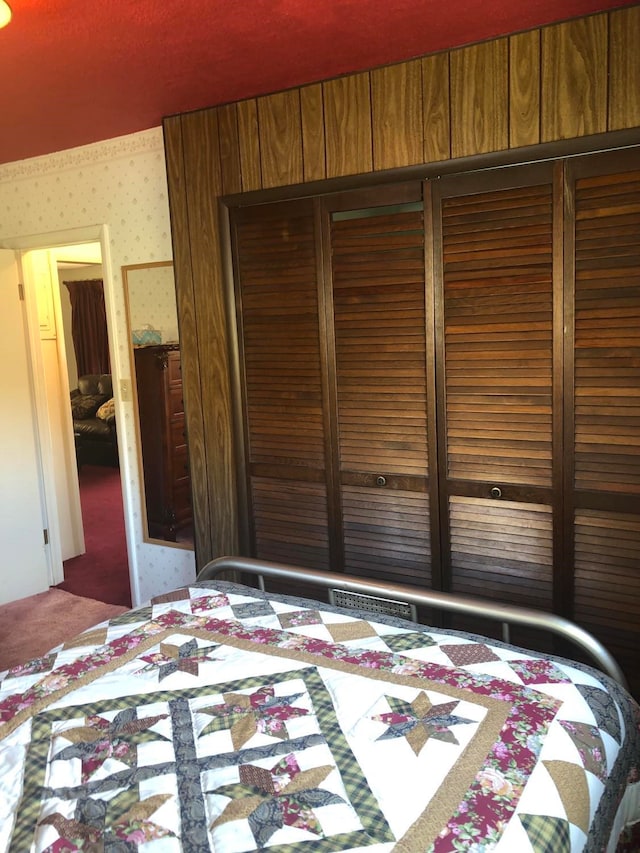 470 Duck Lake Rd, Browning, MT 59417 - bedroom with a closet, carpet floors, and wallpapered walls