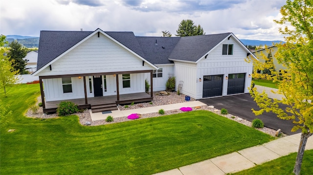modern inspired farmhouse with board and batten siding, a porch, a shingled roof, and a garage