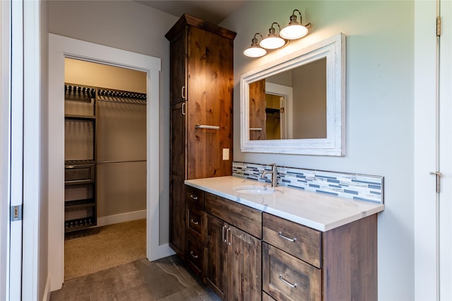 bathroom featuring tasteful backsplash and vanity